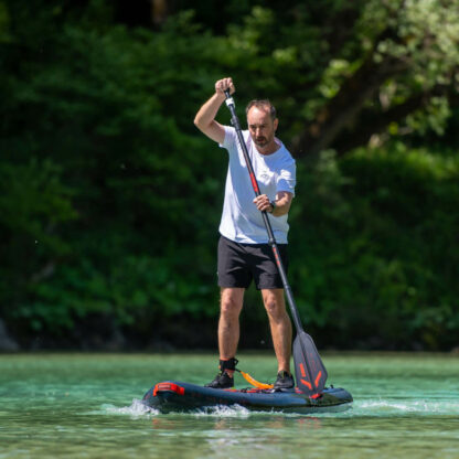 Man paddling with Jobe Stream Carbon 100 Sup Paddle in orange