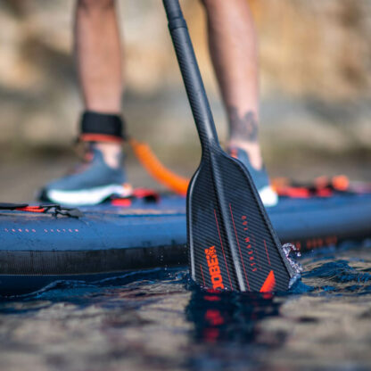 Jobe Stream Carbon 100 Sup Paddle being used next to a paddle board